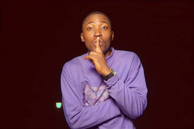 being silent - man with finger to lips